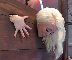 Blonde trapped in wall store ball-sac fucked